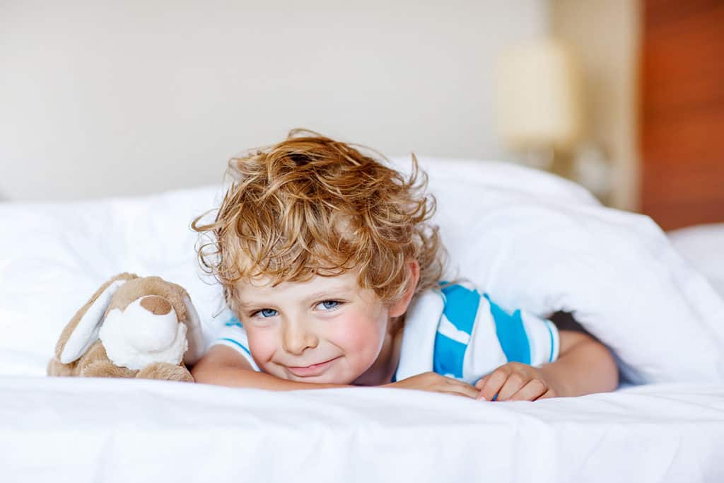 Two Double Beds with Sleeper Sofa boy in a bed