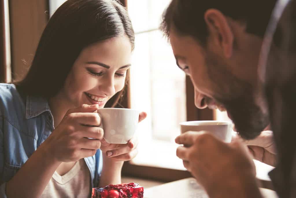 Two Double Beds with Sleeper Sofa couple drinking coffee