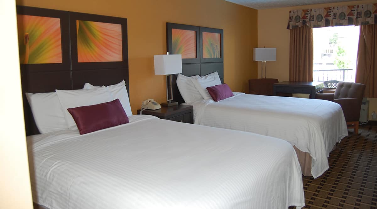 hotel room with two queen beds and balcony