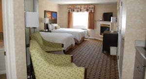 Pigeon Forge hotel room with two queen beds, jet tub, and fireplace