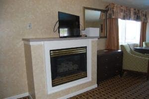 fireplace in hotel suite with two queen beds and jet tub