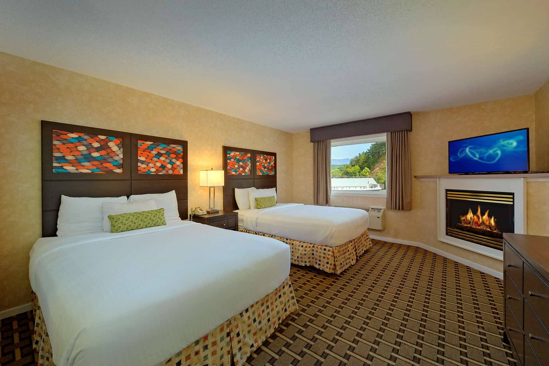 Pigeon Forge hotel suite with 2 queen beds, jet tub, and fireplace