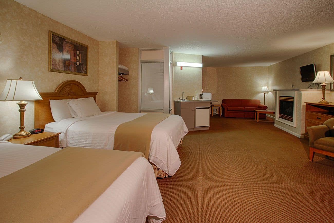 Two queen beds in a Pigeon Forge hotel mini-suite at the Vacation Lodge.