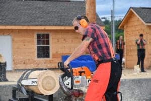 lumberjack cutting wood with a chainsaw