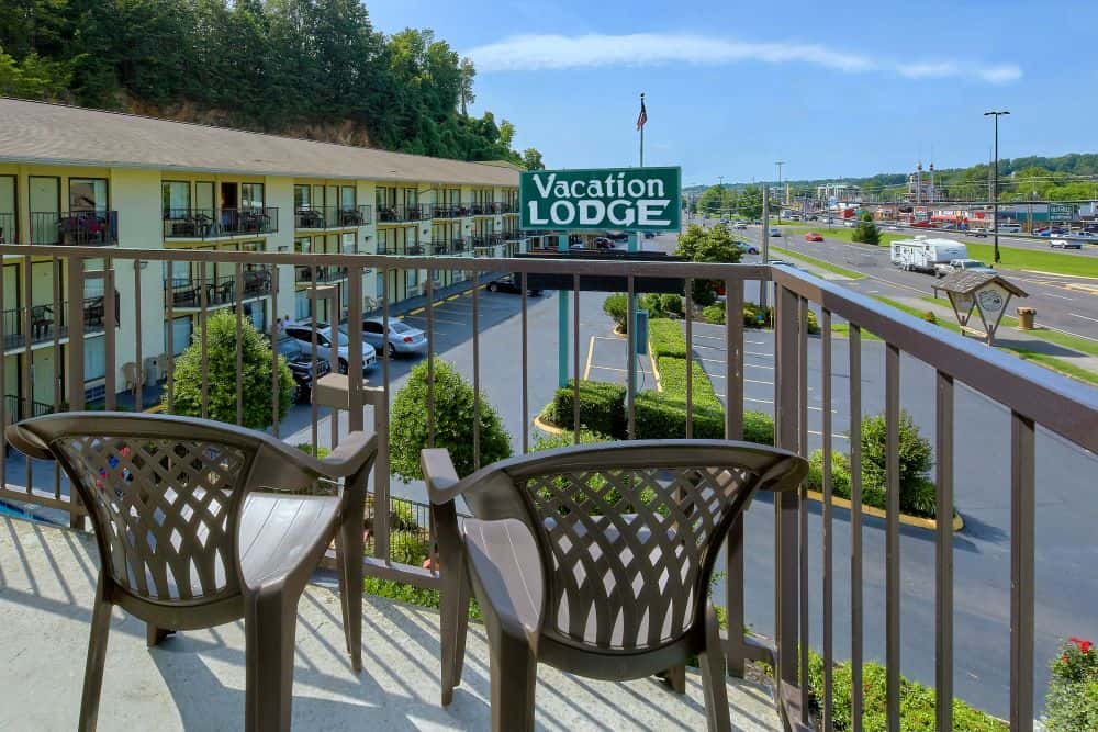 A balcony at the Vacation Lodge overlooks the hotel's sign.