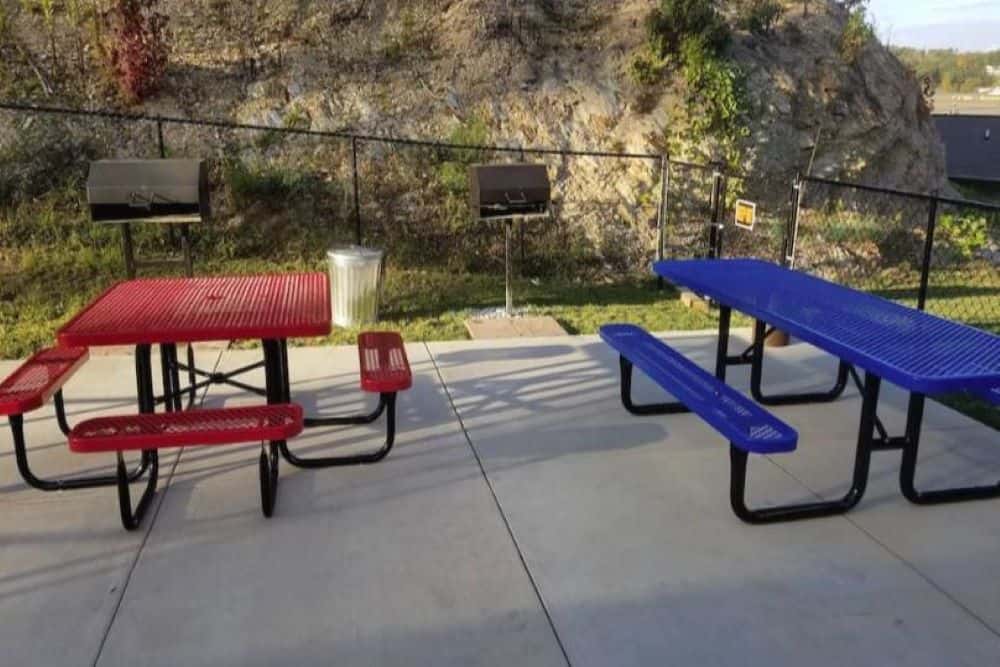 A lovely outdoor picnic area with tables and grills.