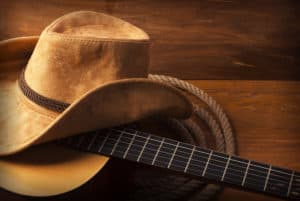 cowboy hat on top of guitar
