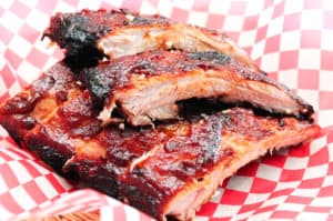 barbecue ribs in a red and white checkered basket
